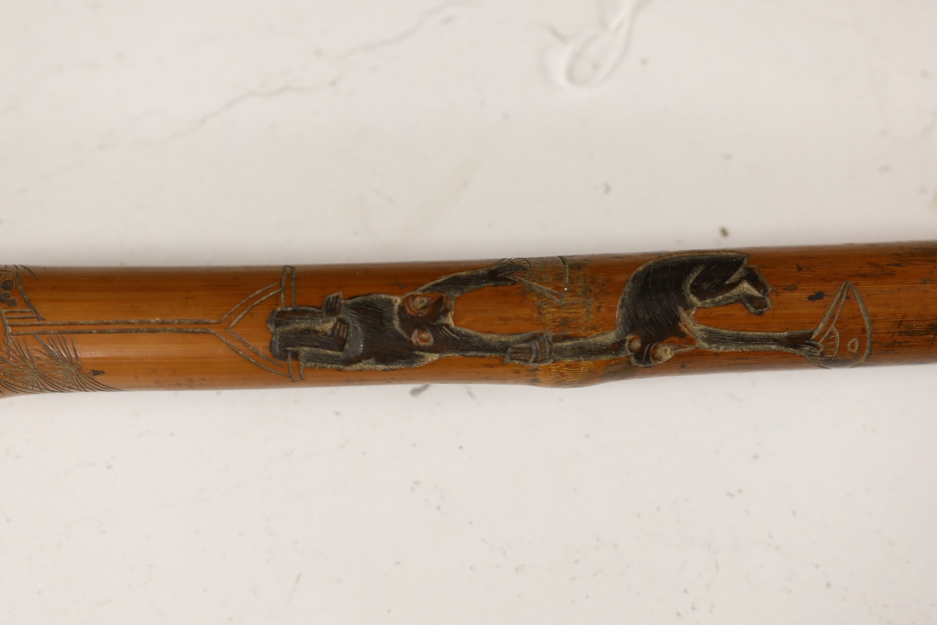 A Japanese carved and signed walking cane, 87cm high. Condition - fair to good